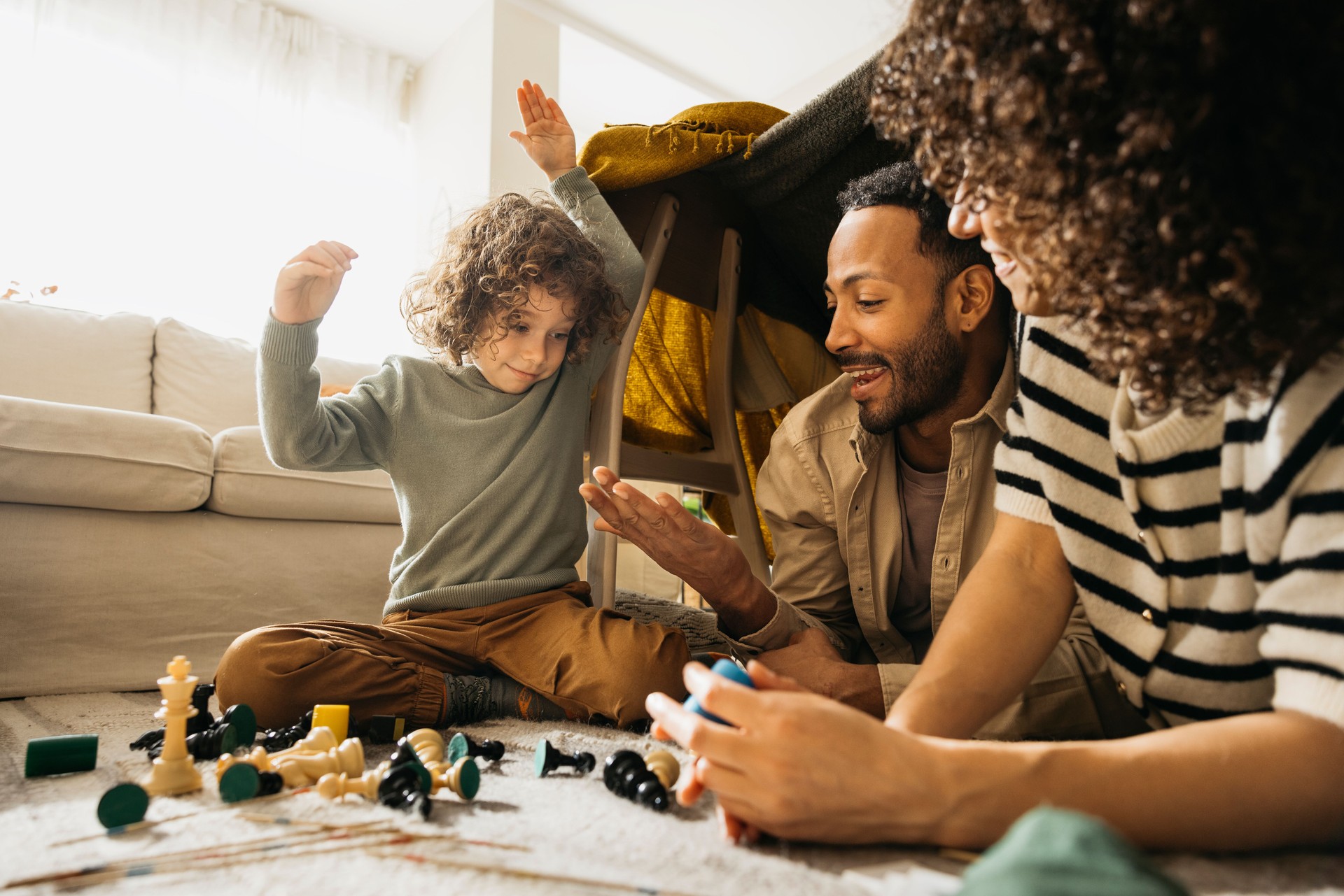 Family enjoying time together playing games in a living room.